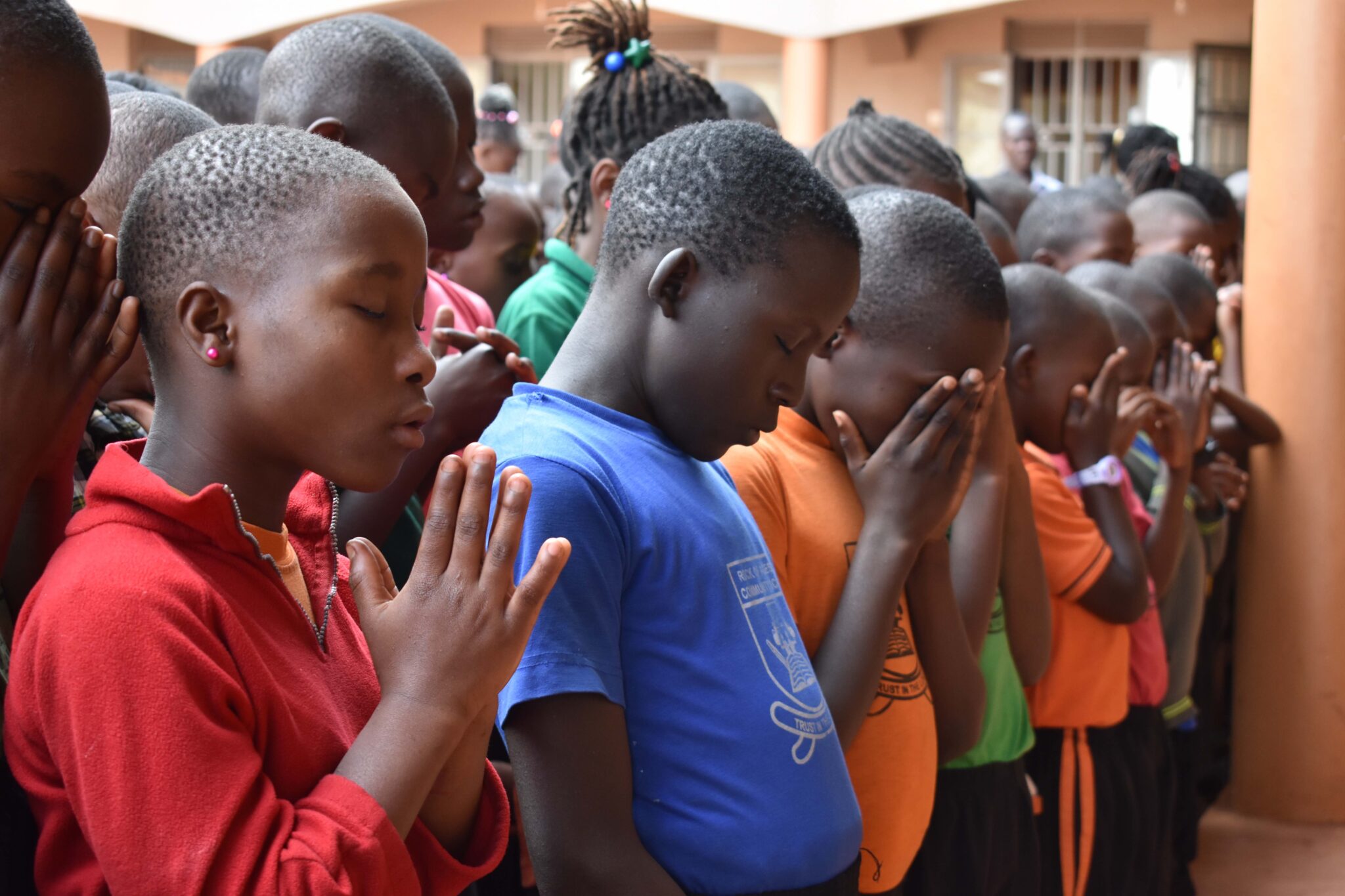 Uganda boys praying.